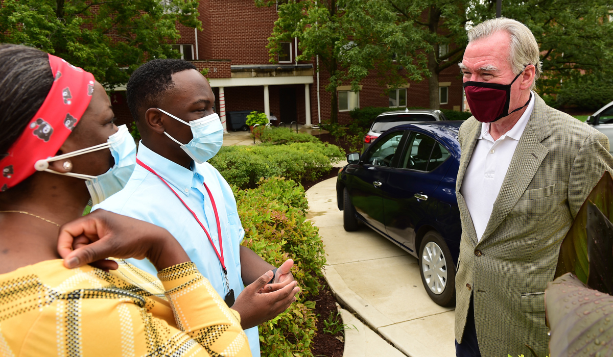 President John Garvey greets parents of a first-year student on move-in day 2020.